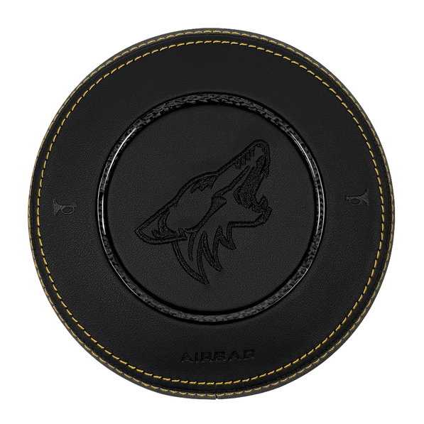 2015–2023 Ford Mustang S550 custom black leather airbag cover with yellow contrast stitching, woven carbon fiber trim ring, and black howling Coyote logo.