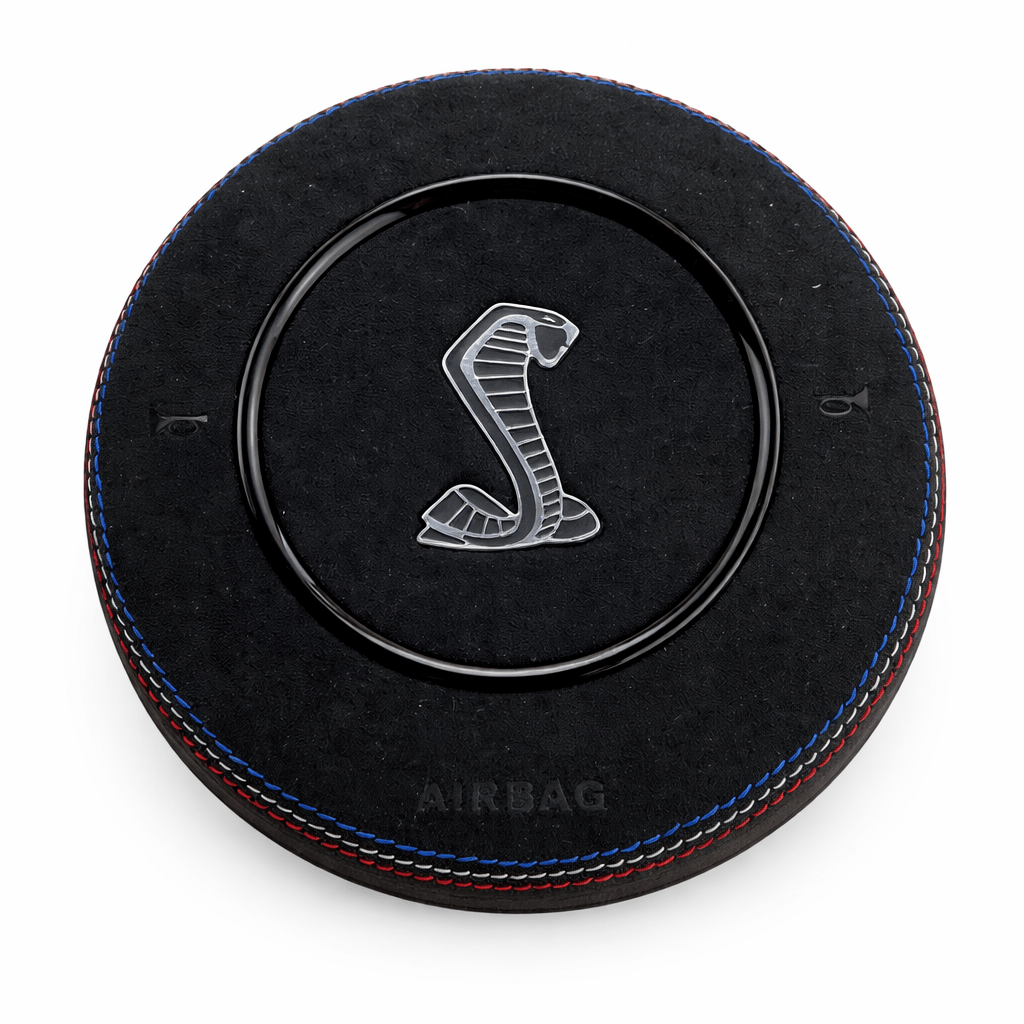 2015-2023 Ford Mustang S550 custom black Alcantara airbag cover with Shelby Cobra emblem, red-and-blue stitching, and gloss black trim ring