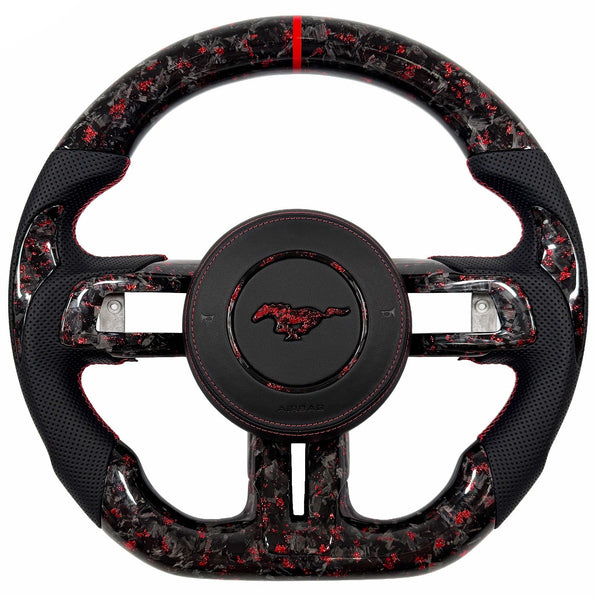 Custom red-flake forged carbon fiber flat-bottom steering wheel for 2015–2023 Ford Mustang S550 with black perforated leather grips, red stitching, and red center stripe.