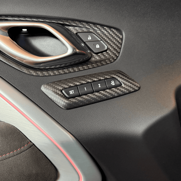 2016-2024 Camaro carbon fiber memory seat button trim installed on interior door panel