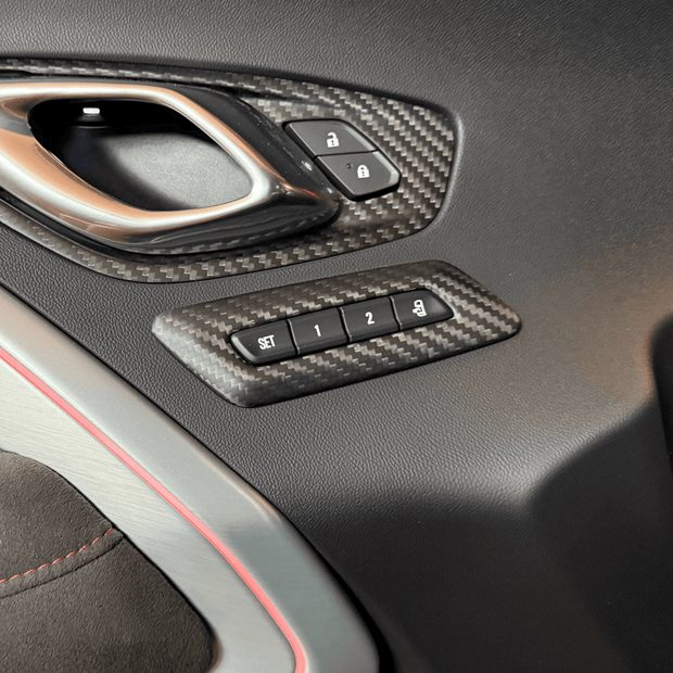 2016-2024 Camaro carbon fiber memory seat button trim installed on interior door panel