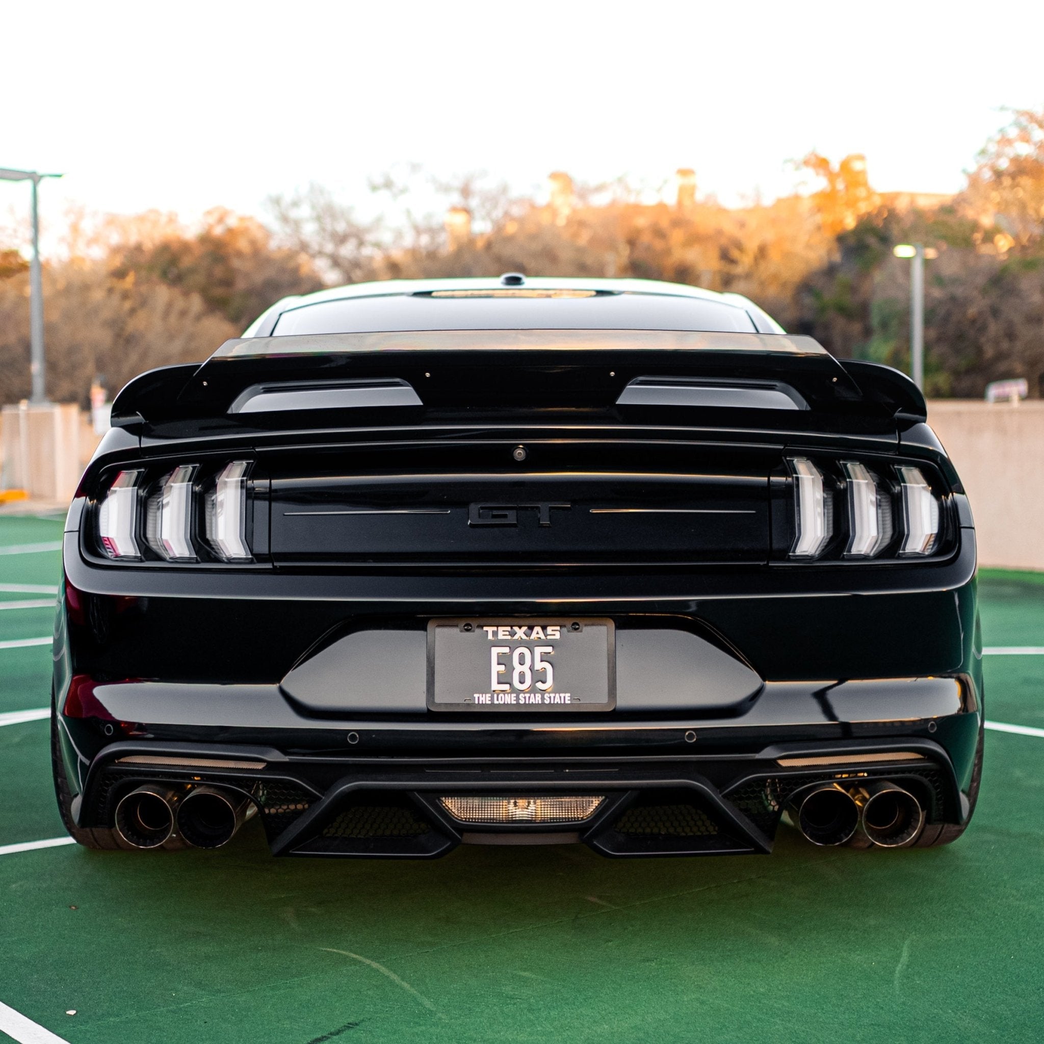 2015-2023 S550 Mustang GT clear lens Euro LED tail lights installed on black Mustang rear view with triple-bar lenses